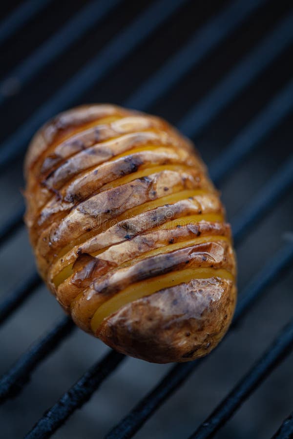 Hasselback Potato on a Bbq Rack. Stock Image Image of dark, close 217968301