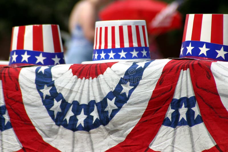 Patriotic, red-white-and-blue hats sit on a draped flag material during the Plano, Texas, Fourth of July parade in 2003. Patriotic, red-white-and-blue hats sit on a draped flag material during the Plano, Texas, Fourth of July parade in 2003.