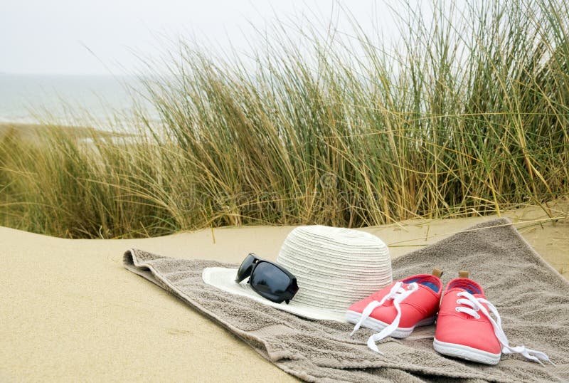 Hat, shoes and sun glasses on beach towel