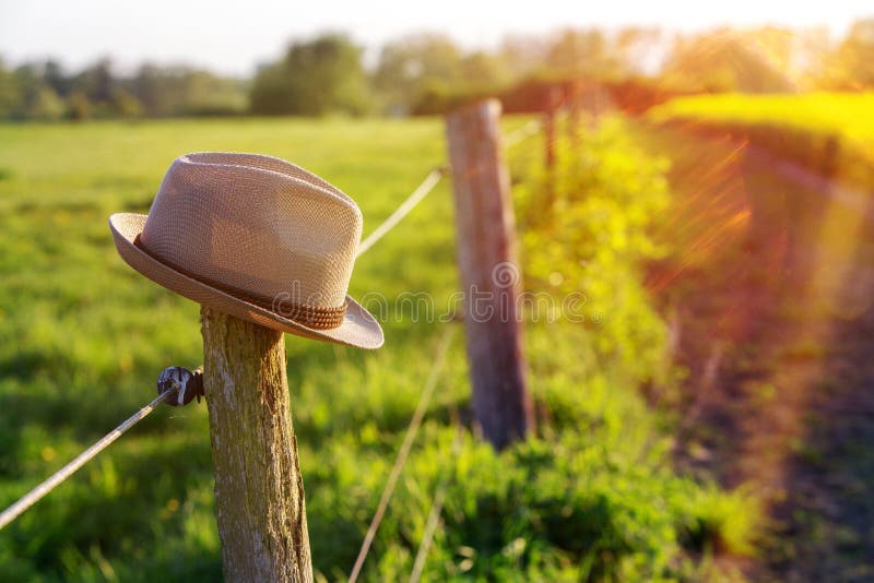 Hat on top of a fence post stock photo. Image of sunny 116340170