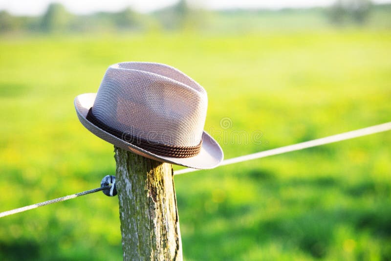 Hat on top of a fence post stock photo. Image of sunny 116340170