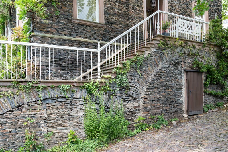 Old house with brick stone facade and stone stairs. Old house with brick stone facade and stone stairs