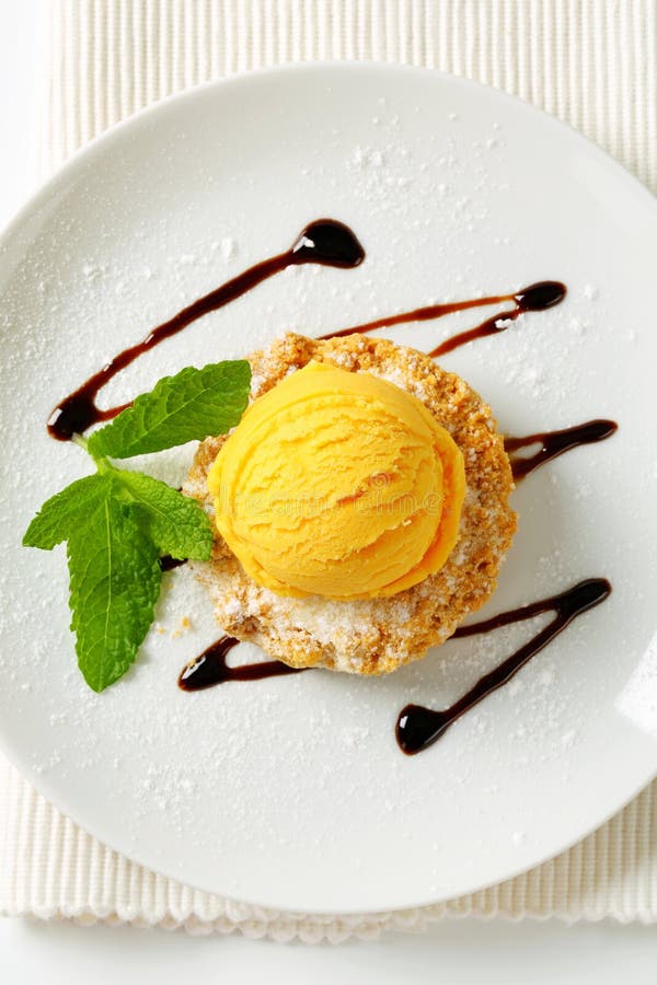 Mini Sbrisolona cookie with scoop of yellow ice cream. Mini Sbrisolona cookie with scoop of yellow ice cream