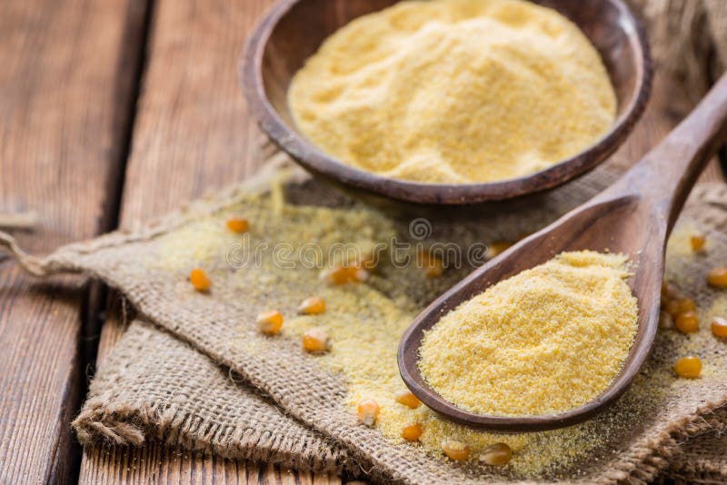 Portion of Cornmeal (on rustic background) as detailed close-up shot. Portion of Cornmeal (on rustic background) as detailed close-up shot