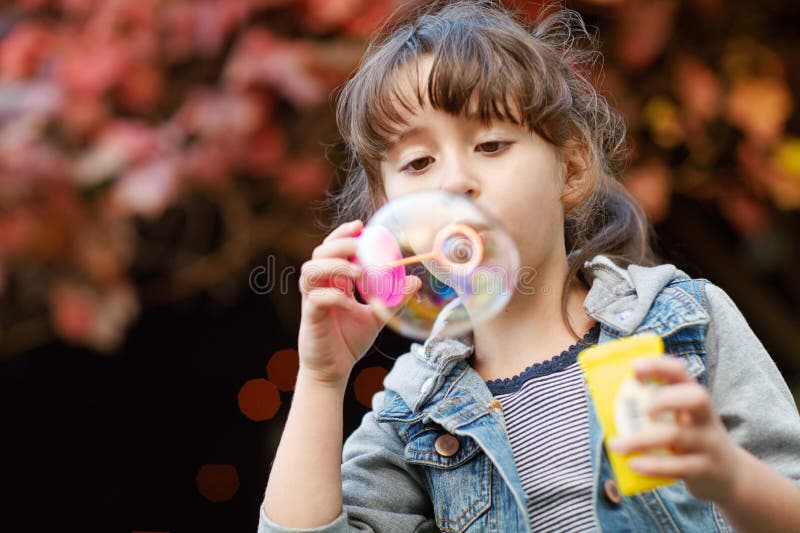 Blowing Bubbles. a Young Woman Blowing Bubbles Outside - Profile. Stock ...