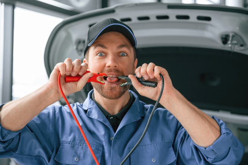 Having Fun with Electrical Terminals, Dangerous. Man in Blue Uniform is