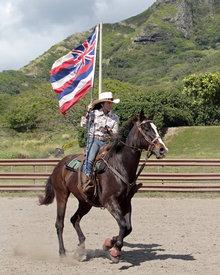 Event: High School Rodeo 08.IV.17 Location: Kualoa Ranch, island of O`ahu, Hawai`i, USA Subject: The official Flag of Hawai`i signifies the oppression of the USA and British nations which overthrew the Hawaiian monarchy. Rodeo Colour Guard rider. Event: High School Rodeo 08.IV.17 Location: Kualoa Ranch, island of O`ahu, Hawai`i, USA Subject: The official Flag of Hawai`i signifies the oppression of the USA and British nations which overthrew the Hawaiian monarchy. Rodeo Colour Guard rider.
