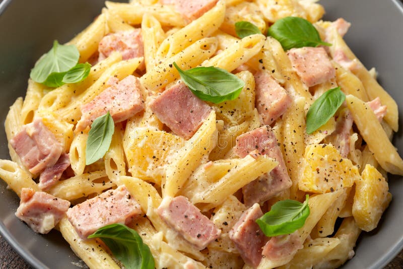 Hawaiian Pasta with Ham, Pineapple and Creamy Cheese. Stock Photo