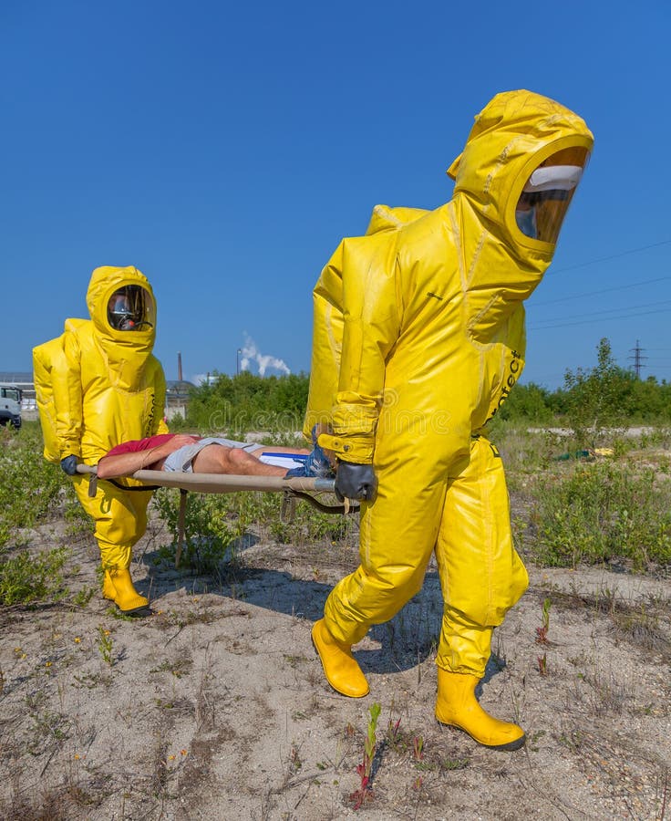 Hazmat team members have been wearing protective suits to protect them from...