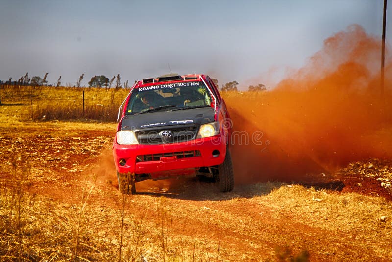 HD RED truck kicking up dust on turn ar rally