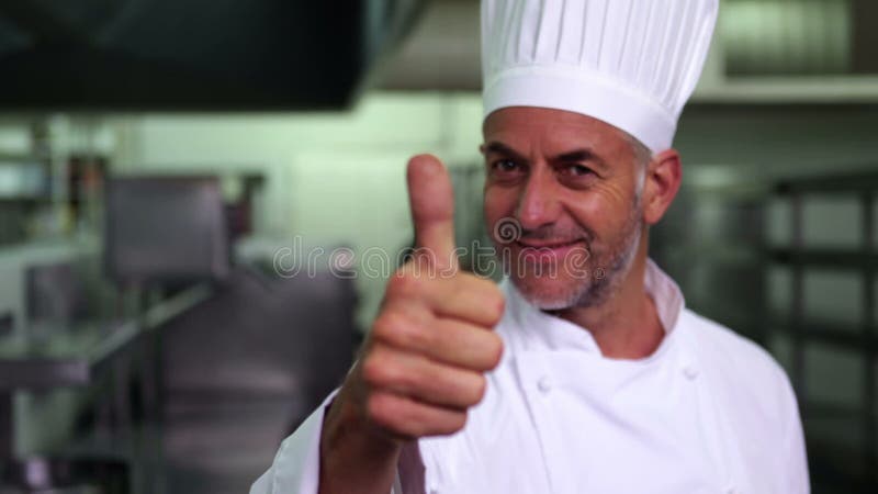 Head chef giving thumbs up and smiling at camera