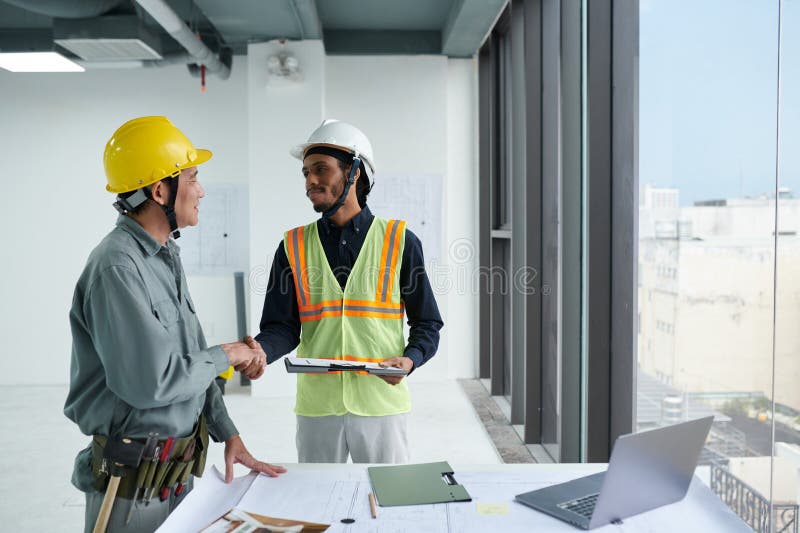 Head Engineer Shaking Hand of Foreman stock image