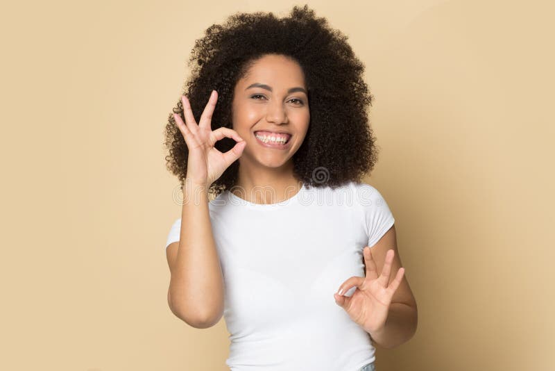 Head shot portrait smiling African American girl speaking sign language