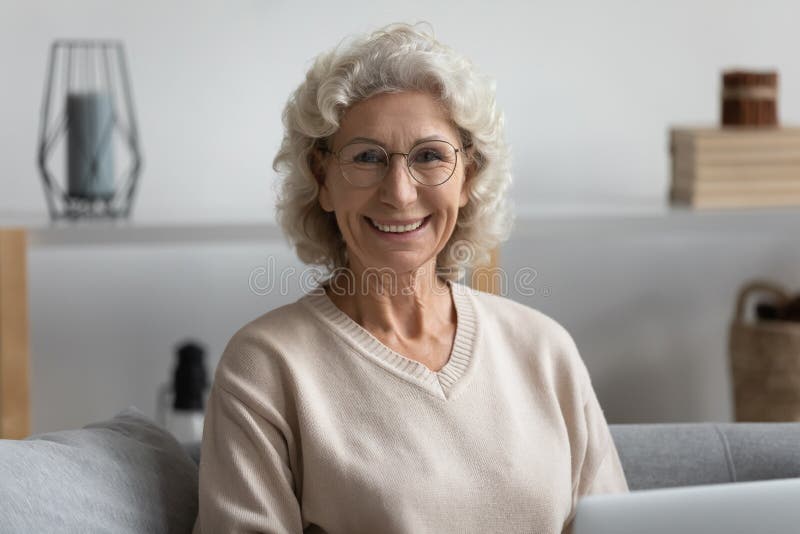 Head Shot Portrait Smiling Mature Woman Wearing Glasses At Home Stock
