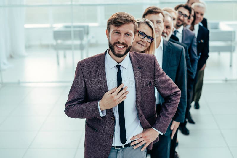 Head standing in front of a group of different business people. royalty free stock images