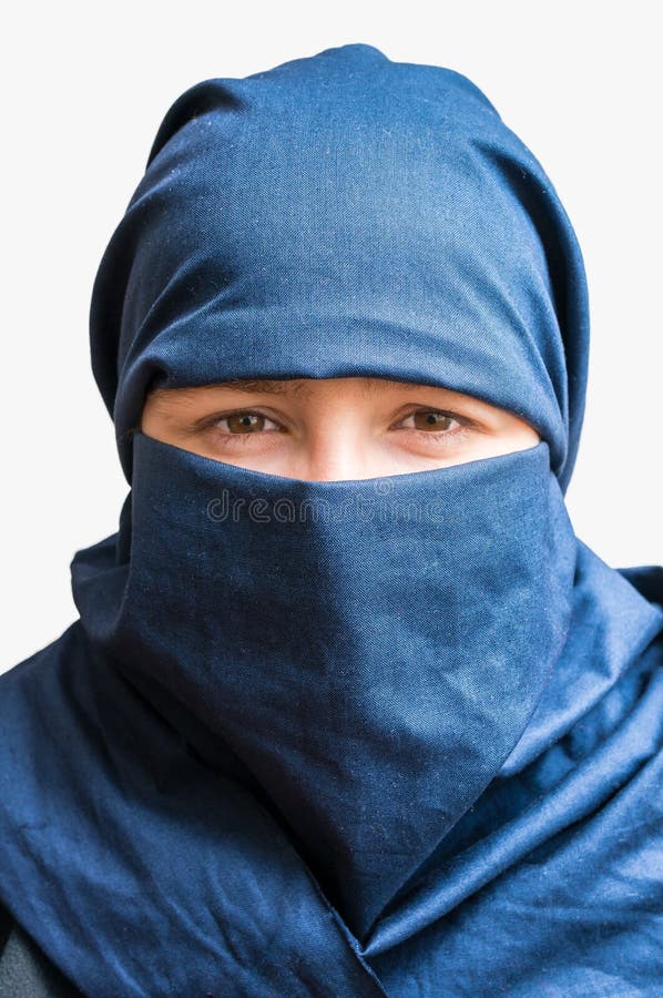 Head of young woman veiled with blue niqab scarf. Isolated on white