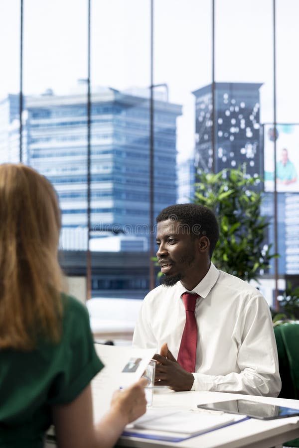 Headhunter negotiating salary package and other benefits with smiling applicant royalty free stock photos