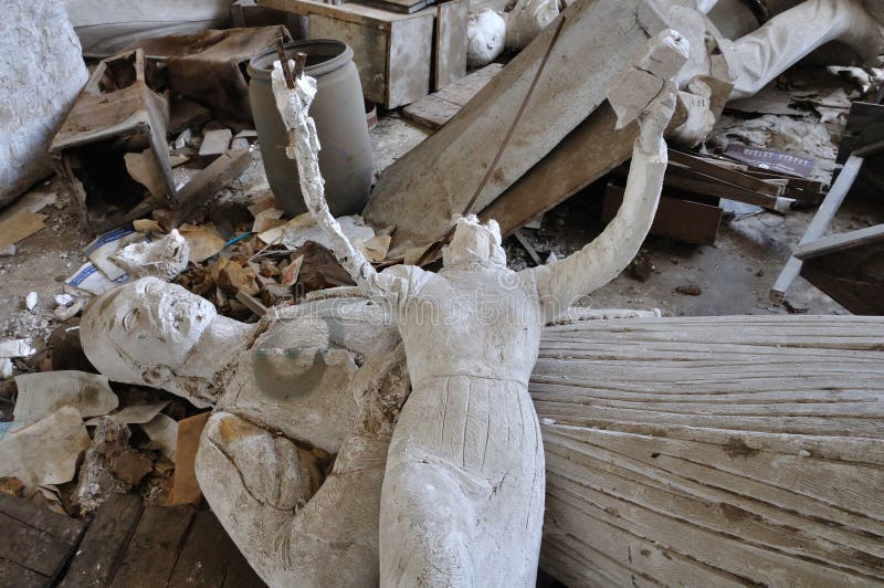 ATHENS - FEBRUARY 3: Headless sculpture ancient goddess Nike and vandalized statue of heroic figure of the Greek Independence War in the abandoned studio of sculptor Nikolaos Pavlopoulos in Athens Greece, February 3, 2012.