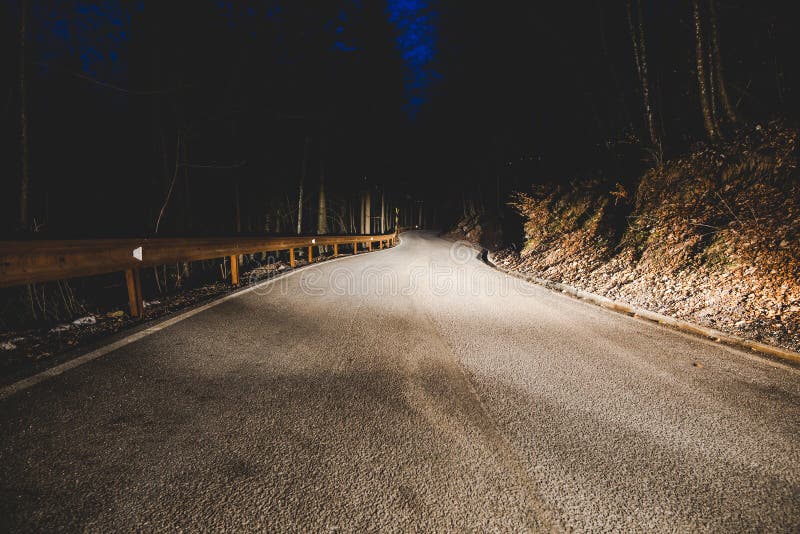 The headlights of a car on mountain road in the night