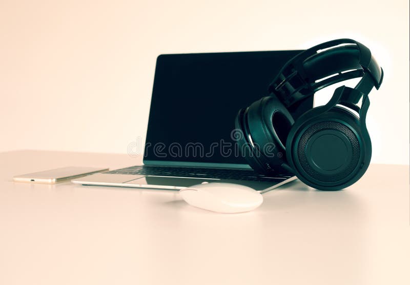 Headphones Black, Smartphone and Laptop on Work Desk. Stock Image