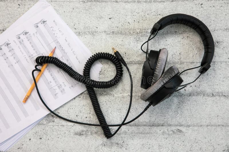 Headphones with cord and music sheet royalty free stock image Headphones with cord and music sheet royalty free stock image