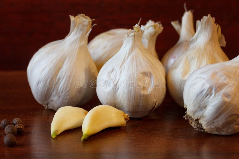Heads Of Garlic And Garlic Cloves Lie On The Background Stock Photo