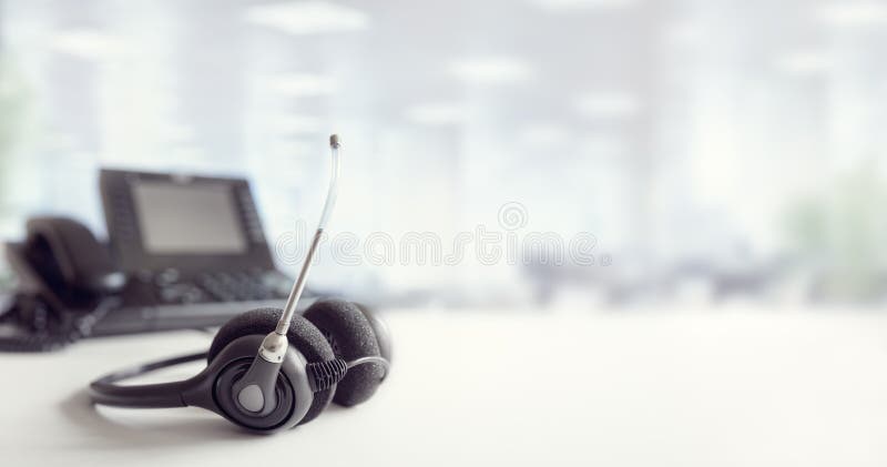 Headset headphones telephone on desk in call center