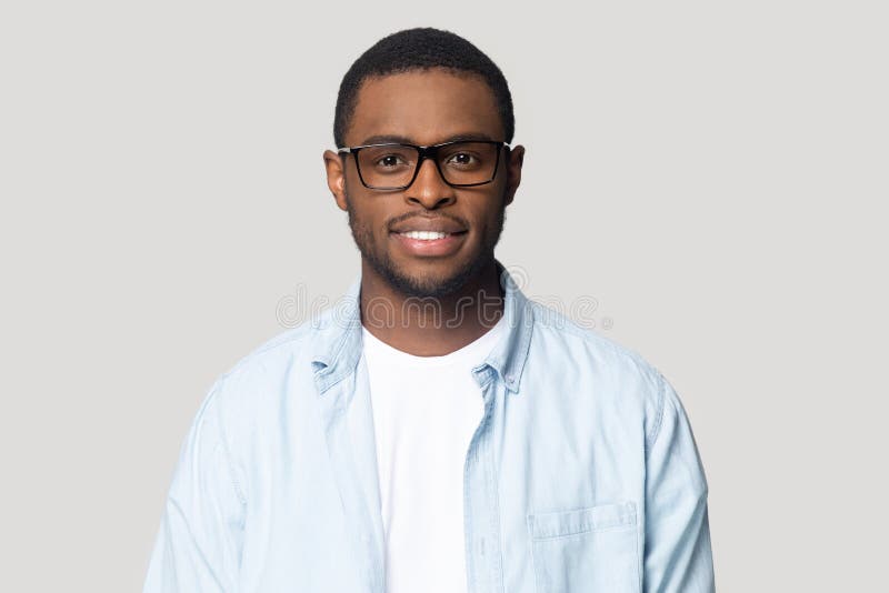 Headshot of african American male in glasses posing in studio