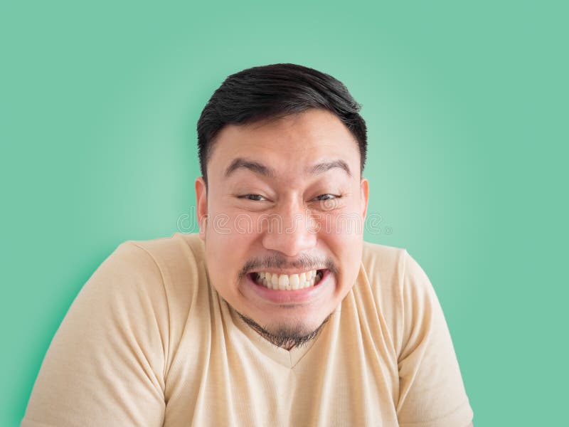 Headshot of funny guilty face of Asian man with beard and mustache. Headshot of funny guilty face of Asian man with beard and mustache.