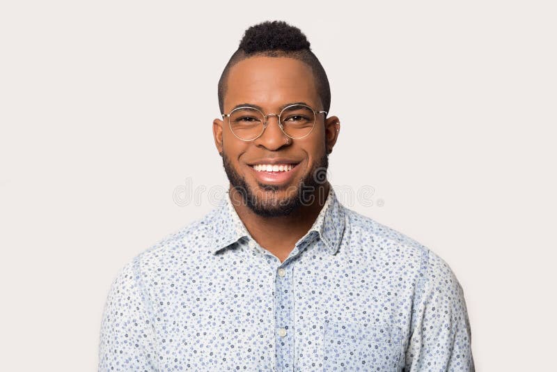 Headshot of black male in glasses isolated on grey background