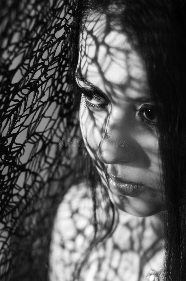 Headshot brunette model using patterned shadows as royalty free stock photos