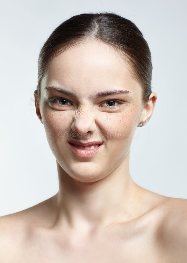 Headshot of emotional female face portrait with disgust pucker facial expression