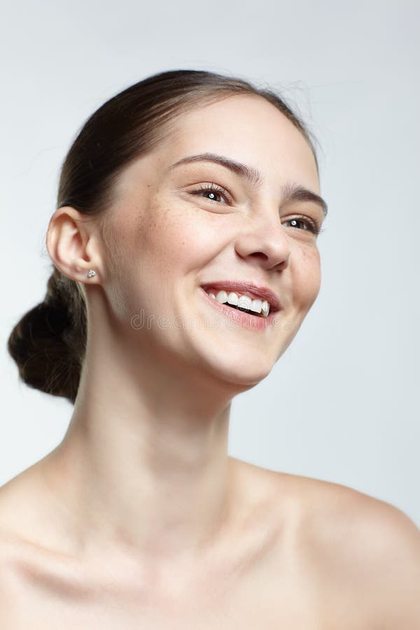 Headshot of emotional female face portrait with serene facial expression