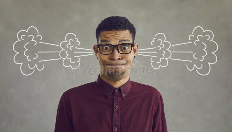 Funny crazy annoyed black man looking at camera with smoke coming out of his ears royalty free stock photo