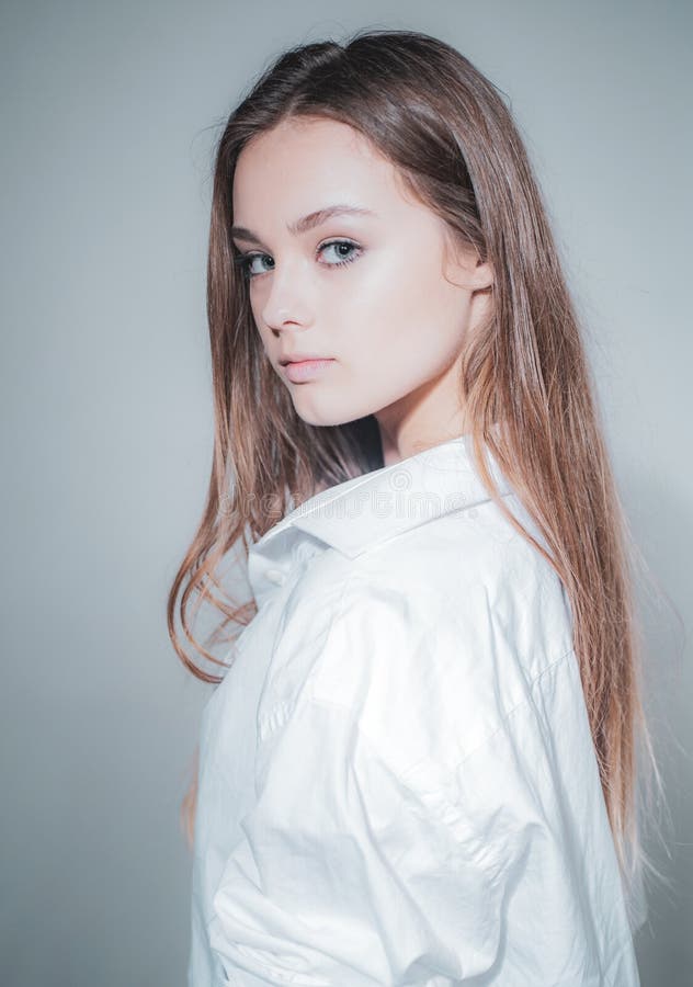 Headshot Portrait of beauty girl with beauty face looking at camera. Close up portrait of young cheerful beautiful girl