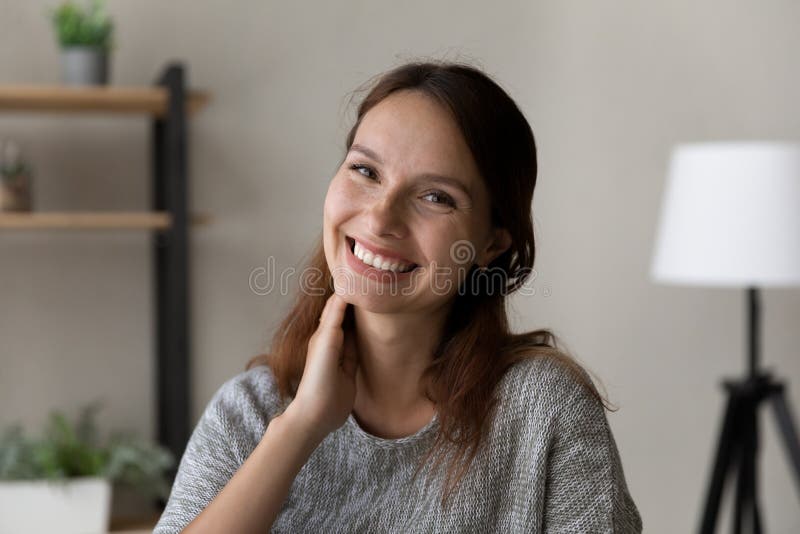 Headshot portrait of smiling Caucasian woman posing at home