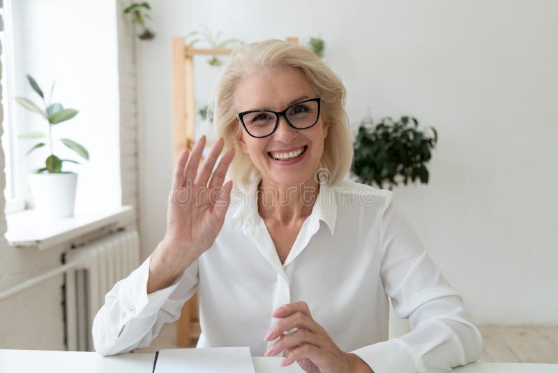 Headshot portrait picture of happy 60 years old businesswoman.