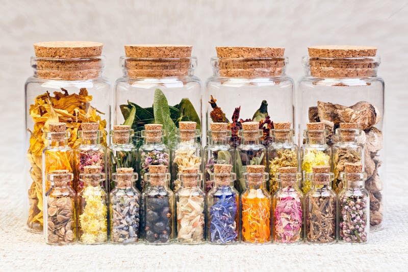 Healing herbs and tinctures in bottles on sackcloth, dried flowe stock photos Healing herbs and tinctures in bottles on sackcloth, dried flowe stock photos