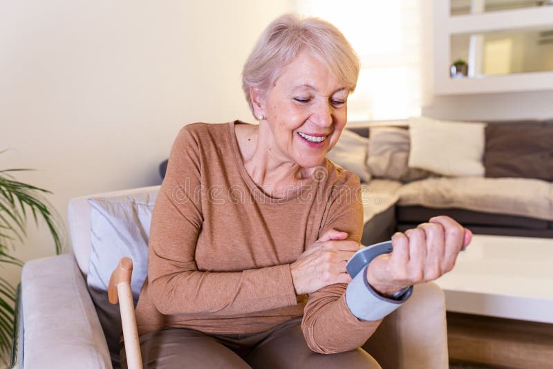 Health concept senior women is taking care for health with blood pressure monitors. High blood pressure. Mature woman measuring