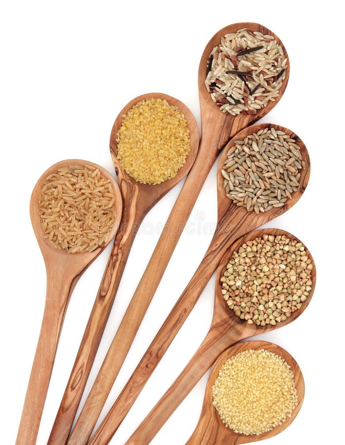 Healthy food of brown and wild rice, bulgur wheat, couscous, rye grain and buckwheat grain in olive wood spoons over white background. Healthy food of brown and wild rice, bulgur wheat, couscous, rye grain and buckwheat grain in olive wood spoons over white background.