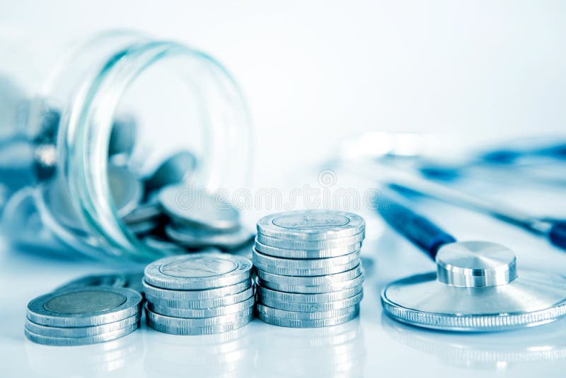 Health  insurance and Money saving for Medical Healthcare disease insurance concept , a coin money jar with stethoscope