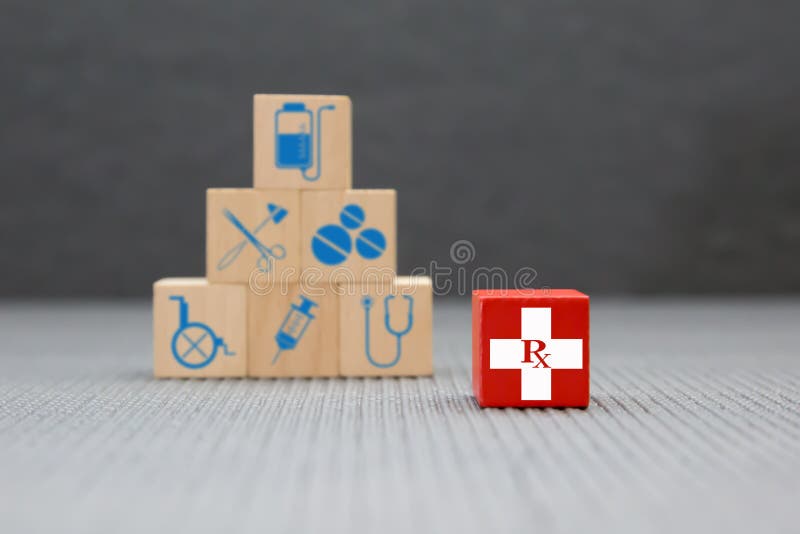 Health and medical icons on wooden toy blocks stacked in pyramid shape. Concepts a physical examination for health care and medical insurance