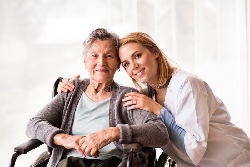 Health visitor and a senior woman during home visit.