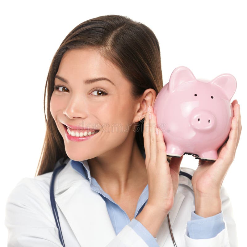 Healthcare concept - doctor holding piggy bank