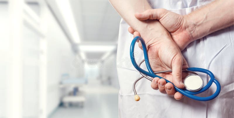 Healthcare And Medicine concept. Doctor. Unrecognizable Male Doctor Hands With Stethoscope Behind His Back, Closeup