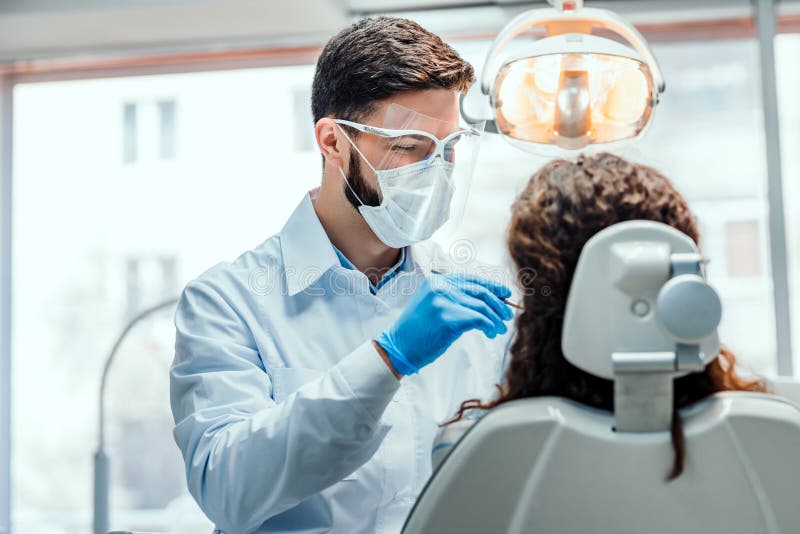 Healthcare and medicine concept.Young dentist working with the female patient in a modern hospital royalty free stock images Healthcare and medicine concept.Young dentist working with the female patient in a modern hospital royalty free stock images