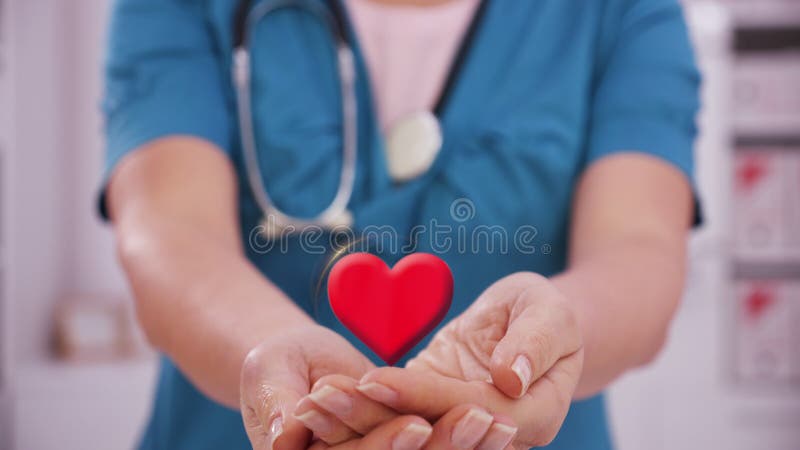 Healthcare professional holding heart shape in hand - medical service concept