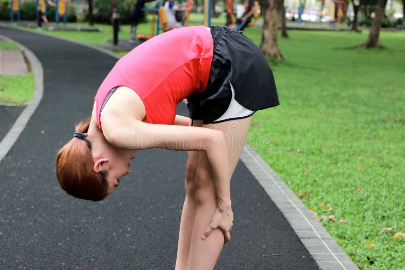 Healthy Asian Woman Stretching Her Legs Before Run In Park Fitness And 