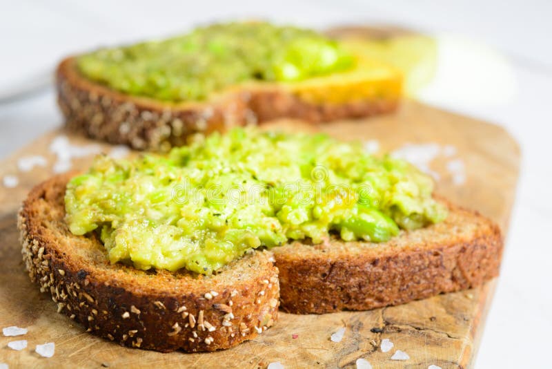 Healthy Avocado Toast with Spices on Whole Wheat Bread Stock Photo