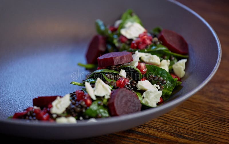 Healthy Beet Salad with fresh sweet baby spinach, kale lettuce, nuts, feta cheese and toast melted.